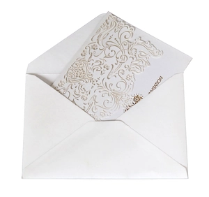 Laser cut white wedding invitation card set with elegant floral patterns and envelope