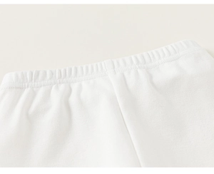 Close-up of soft white cotton knit waistband with elastic band on toddler girl's pants