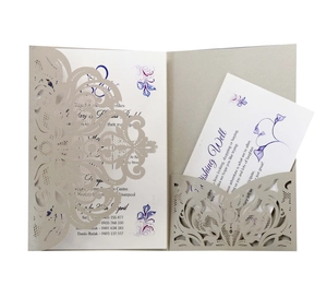 Detailed macro view of laser-cut champagne gold floral invitation with purple inner cards