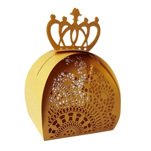 Elegant gold hollow paper gift box featuring a crown handle and laser-cut floral patterns