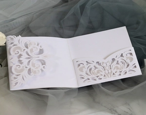 Elegant white laser cut wedding invitation pocket with intricate floral vine patterns