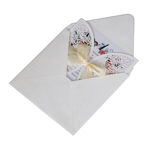 Elegant laser-cut rose wedding invitation set with cream cover, ribbon and floral inner card