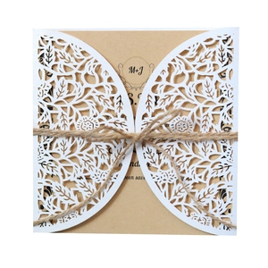 Elegant laser-cut floral wedding invitation set with kraft paper and rustic twine bow