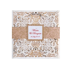 Elegant white laser-cut wedding invitation card with gold glitter band and mandala pattern