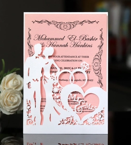 Detail of laser-cut wedding invitation featuring pink backing and Mr. & Mrs. silhouette