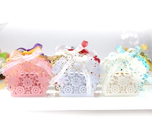 Elegant floral laser cut candy boxes with ribbons for wedding party favors and gift packing