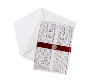 Dark red laser-cut wedding invitation with elegant white floral lace and rhinestone ribbon