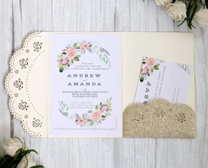 Detail of rose gold laser-cut floral wedding invitation with glitter insert and RSVP card