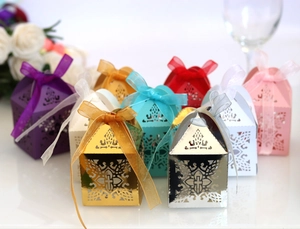 Golden laser cut cross candy boxes with ribbons for elegant wedding party decorations