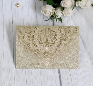 Detailed laser cut gold glitter wedding invitation card with mandala lace pattern and heart