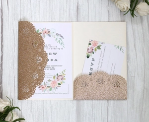 Detail of rose gold glitter laser-cut invitation with floral main card and RSVP set