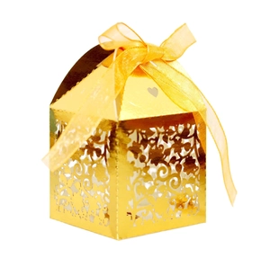 Elegant gold laser-cut hollow floral wedding favor box with heart detail and yellow ribbon