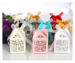 Laser cut European style wedding favor boxes with elegant floral hollow patterns and ribbons