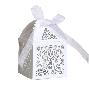 Laser cut white wedding favor box with floral patterns and a silk ribbon bow