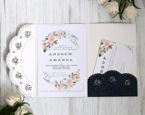 Detail of rose gold lace laser-cut wedding invitation with floral card and navy glitter RSVP pocket