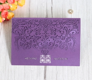 Detail of laser-cut purple floral invitation with double happiness symbol on wood