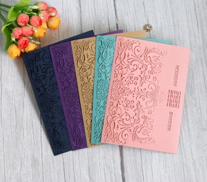 Detailed laser-cut wedding invitation cards in pink, blue, and gold with Xi character