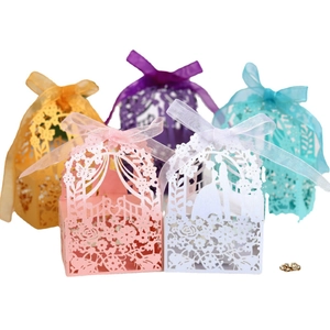 Laser-cut hollow wedding favor boxes with floral patterns and silk ribbon bows