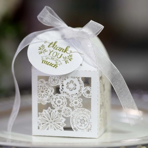 White laser cut floral wedding favor box with ribbon and thank you gift tag