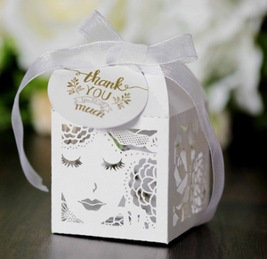 Elegant white laser-cut rose favor box with ribbon and gold-stamped tag for parties