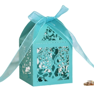 Laser-cut Tiffany blue hollow favor box with floral patterns and a matching ribbon bow