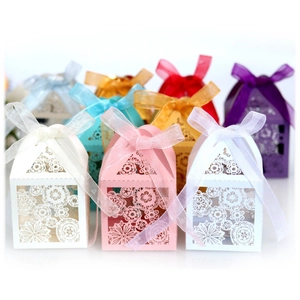 Laser-cut floral wedding favor boxes with organza ribbons in assorted vibrant colors