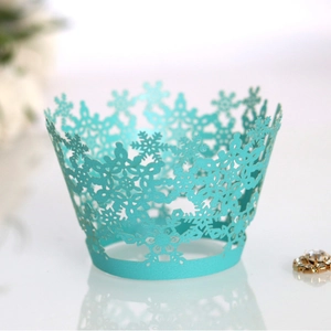 Teal laser-cut snowflake cupcake wrappers for Christmas and winter holiday table decor
