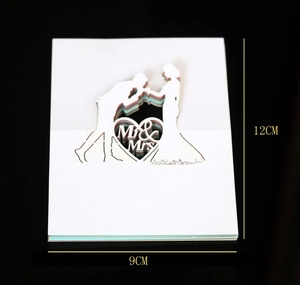 Detail of laser-cut Mr & Mrs wedding place card with dimensions 9x12cm on black background
