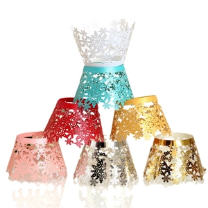 Laser-cut snowflake cupcake liners in multiple colors including gold, silver, and red