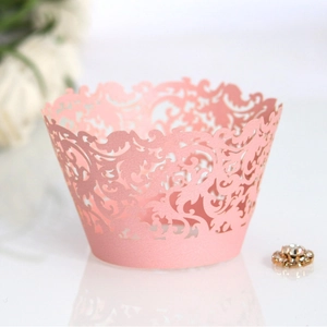 Elegant laser cut pink lace cupcake wrappers with intricate floral vine patterns