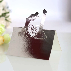 Laser-cut silver pearlescent wedding place card with Mr & Mrs silhouette design