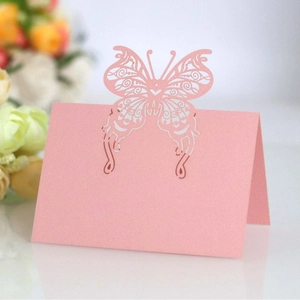 Pink laser-cut butterfly table place cards with elegant hollow design for weddings