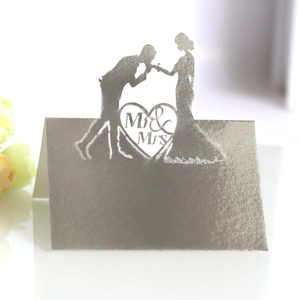 Silver laser-cut Mr & Mrs wedding place card featuring a romantic couple silhouette