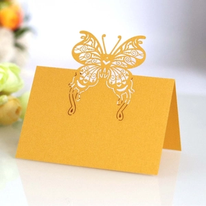 Golden laser cut butterfly place cards made of pearl paper for elegant wedding table decor