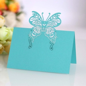 Laser-cut cyan butterfly place cards for weddings featuring elegant hollow pearlescent paper