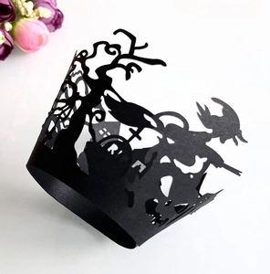 Detail of laser-cut Halloween cupcake wrapper featuring witch and bat silhouettes