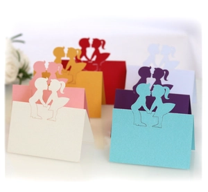 Laser cut wedding place cards featuring boy and girl silhouettes in multiple colors