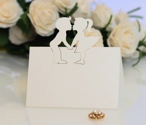 Detailed laser-cut white wedding place card with romantic boy and girl silhouette