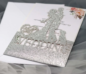 Macro detail of silver glitter wedding silhouette topper with laser-cut lettering