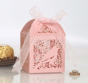 Pink laser-cut candy gift box with bird patterns and elegant ribbon for weddings