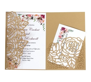 Laser cut floral wedding invitation suite with intricate rose patterns and gold cardstock
