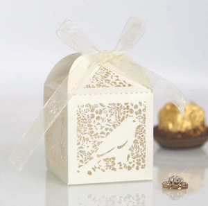 European style white laser-cut favor box with bird patterns and white organza ribbon bow