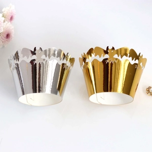 Golden and silver Halloween cupcake wrappers featuring laser-cut bat wing decorations