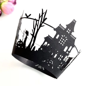 Macro detail of laser-cut Halloween castle cupcake wrapper in black matte paper