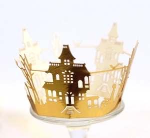 Detailed laser cut gold mirror paper cupcake wrapper with spooky Halloween castle and bats