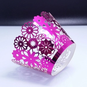 Metallic magenta laser-cut hollow lace cupcake wrapper with intricate floral patterns