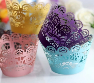 Detailed laser-cut lace cupcake wrappers in gold, purple, pink, and light blue finishes