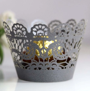 Close-up of laser-cut lace cupcake wrapper in dark grey pearlescent paper finish