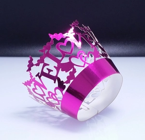 Magenta laser-cut cupcake wrappers with LOVE cutout design and metallic crown finish