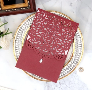 Detailed laser-cut rose hollow invitation with teardrop diamond on elegant tray